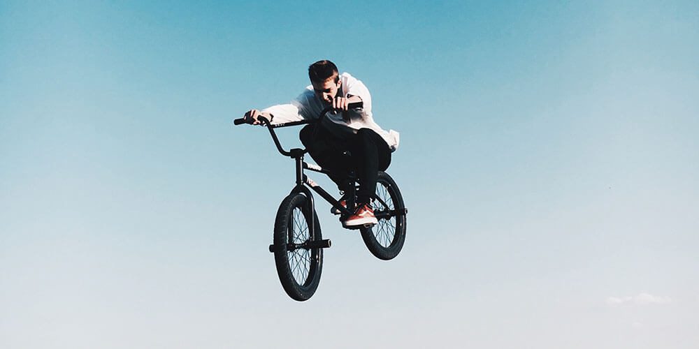 Boy on bmx bike doing stunts