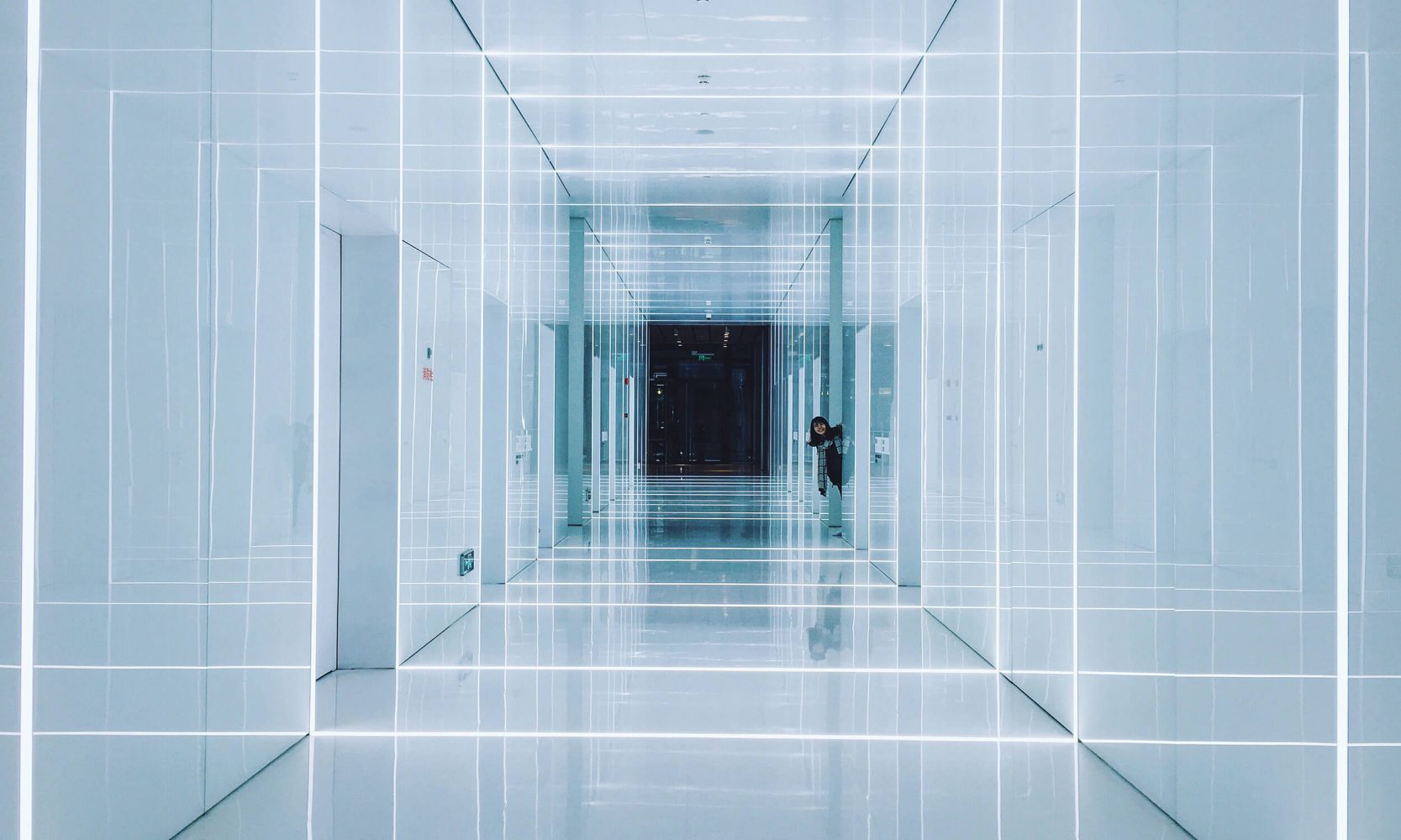 woman in corridor with light optical illusion